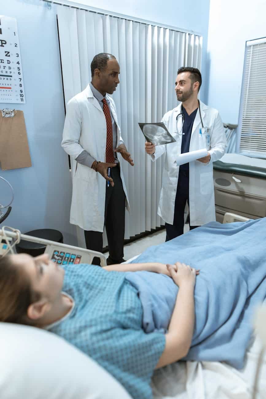 doctors talking beside the patient